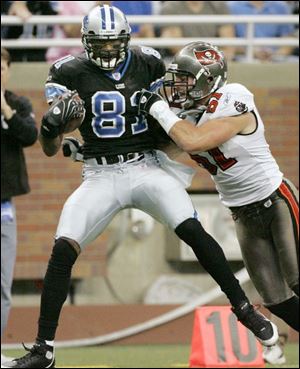 Detroit's Calvin Johnson breaks Barrett Ruud's tackle to help his 32-yard end-around scoring play yesterday.
<br>
<img src=http://www.toledoblade.com/assets/gif/TO17150419.GIF> VIEW: <a href=