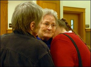 Laura Barnett, mother of drowning victim James Barnett, is comforted in court by her daughters, Sharon Young, left, and Lora Snow.