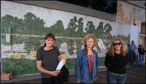 Sara Beth Miller, left, Joan Harris, and Susan Carr hope to rewrite a city ordinance banning murals on buildings in Monroe.