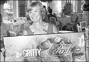 Julie Rubini with a poster from the Jamie Farr tournament
signed by golfers Natalie Gulbis, Morgan Pressel, and Paula Creamer. It was auctioned at the Toledo Country Club outing.