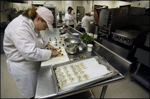 Lori Smith, a culinary arts student at Owens Community College, makes date-filled won tons for the Terrace View Caf<0x00E9>, which is open to the public for the first time.