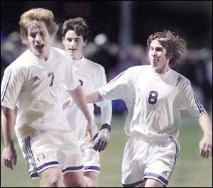 Patrick Pickering (7) celebrates his goal with teammates, a goal that gave St. John's a 2-0 lead against St. Francis.