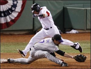 Boston s Dustin Pedroia is out at first as Colorado s Todd Helton
stretches to make the play in the bottom of the fifth.
