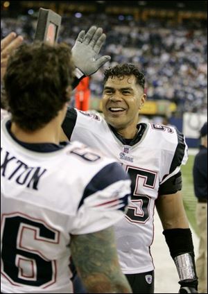 The Patriots' Junior Seau, right, celebrates with Lonie Paxton after New England rallied to beat Indianapolis 24-20 Sunday.