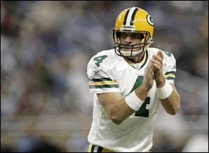 Green Bay quarterback Brett Favre claps after Greg Jennings grabbed a four-yard TD pass in the third quarter at Detroit.
