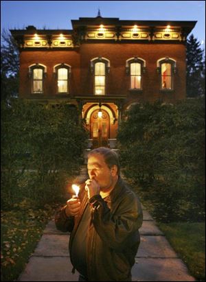 Current owner Tim Mussard lights up a cigar in front of his 1870 mansion in Berea, Ohio. Mr. Mussard and his wife, both singers, intend to hold concerts in the downtown mansion. the plain dealer The Berea mansion, which was nearly destroyed by fire, features brick and stonework.