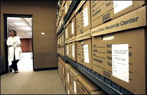 Kim Brownlee pauses in UT s Canaday Center, which has added to its collection of materials about the glass industry.
