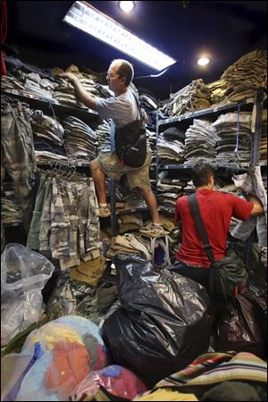 Abercrombie agents identify fake items at a store in Bangkok.
