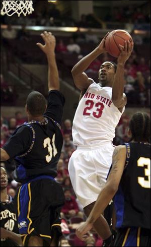 David Lighty slices his way between Coppin State's Eddie Hayden, left, and Julian Conyers during the first half.
