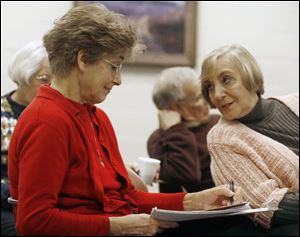 Jackie Fletcher, left, and Nancy Cook take notes during a training session by Michigan State Capitol Tour Service guide Valerie Marvin at the Tiffin library. The training shows preservationists how to lead tours of the Seneca County Courthouse. 