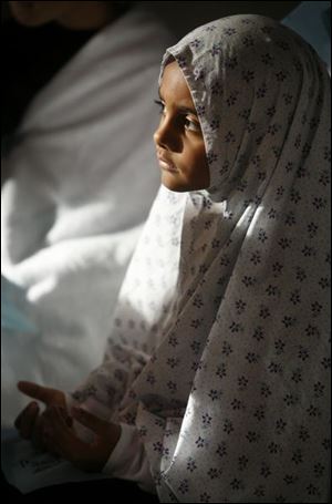 Israa Hamdan, 7, is among the pupils dressing in traditional garb and prayer clothing.