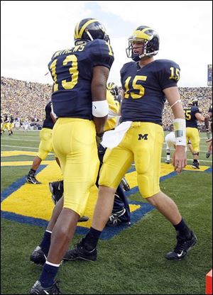 University of Michigan wide receiver Greg Mathews and quarterback Ryan Mallett celebrate Mathews second quarter touchdown reception from Mallett against Notre Dame Saturday, 09/15/2007.         