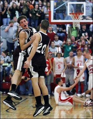 Genoa's Kyle Schimming, left, and Matt Bassitt have a celebratory chest bump after the Comets beat Eastwood in triple overtime. Both teams are 10-2, 7-1 in the SLL. (THE BLADE/JEREMY WADSWORTH)
<br>
<br>
<img src=http://www.toledoblade.com/graphics/icons/photo.gif> VIEW: <a href=