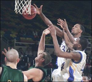 Libbey's Julius Wells (34) and William Buford have the upper hand against Clay's Drew Kuns, left, and Zac Taylor. (BLADE PHOTOS/LORI KING)
<br>
<br>
<img src=http://www.toledoblade.com/graphics/icons/photo.gif> VIEW: <a href=