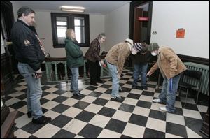 Jim and Rose Dariano, left, Marge Alpay, Josh Dariano, Josh Englehart, and Zac Dolch look at fossils in the courthouse floor. the blade/lori king The public can see the 1884 Seneca County Courthouse when tours continue today.