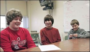 Three members of team CART at Swanton Middle School: Chaz Schmidt, left, Andrew Foore and Rocky Robinson talk over their entry.