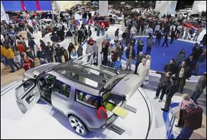 Enthusiasts flock around the Ford Explorer America concept car at the auto show, which is now open to the public.
