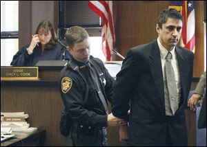 Deputy Mike Willinger handcuffs David Wilton after his conviction in a child-porn case.