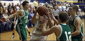 Toledo Christian s Kyle Whitlow (13.4 points) drives againstOttawa Hills  Kevin Nugent. The Eagles are 15-1, 9-1 in the TAAC).