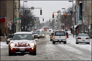 Adams Street in downtown Toledo was snow-covered Friday morning. No major injury crashes were reported in the region.