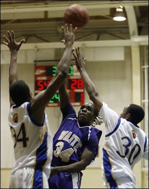 Waite's Hakeem Muhammad hoists a shot over Libbey's Julius Wells (34) and Lance Jones (30).