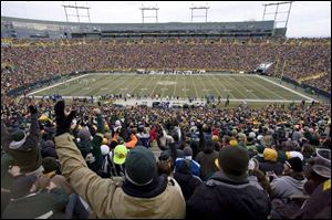 Green Bay Packer fans celebrate a touchdown at Lambeau Field. Tuckahoe Turf Farms of New Jersey supplies the field's grass. 