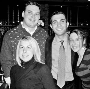 Morgan Bayer, foreground, and Reed Lawless, left, Derek Feniger, and Laura Newenschwander meet at Bar Louie for a Focus on Young People event.