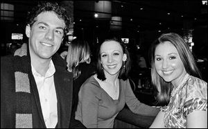 Ben Konop, left, talks with Nicole Tarbet and Kylie Conway at the Focus on Young People gathering at Bar Louie.

