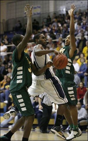 Jeremy Jones passes between Start s DeVore Clark, left, and Dwain Gollady. The senior averages 7.3 points and 2.9 assists.