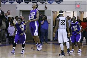 Waite s Robert Jackson (23) celebrates his game-winning basket with teammates Hakeem Muhammad, left, and Khari Riley.