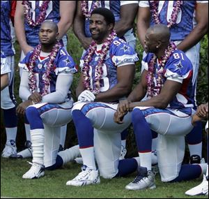 Cowboys linebacker Greg Ellis, center, is flanked by fellow Pro Bowl players Terence Newman, left, and Terrell Owens.