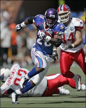 The NFC's Adrian Peterson darts through the AFC defense for a big gain in the second quarter.
