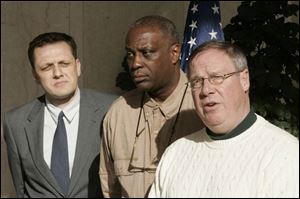 Toledo City Council members, from left, Frank Szollosi, Michael Ashford, and D. Michael Collins propose a resolution apologizing to the members of Company A, 1st Battalion, 24th Marines. (THE BLADE/JETTA FRASER)
<br>
<img src=http://www.toledoblade.com/graphics/icons/photo.gif> <b><font color=red>PHOTO GALLERY</b></font color=red>: <a href=