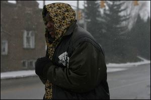 James Wright is bundled up against the bitter cold as he waits for the bus at Oak and Woodville streets on the east side. Today's temperatures aren't expected to be any better. (THE BLADE/AMY E. VOIGT)
<br>
<img src=http://www.toledoblade.com/graphics/icons/photo.gif> <b><font color=red>VIEW</b></font color=red>: <a href=