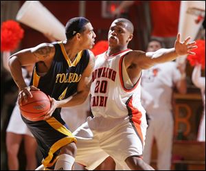 The Falcons  Nate Miller, who led Bowling Green with 21 points, applies the defensive pressure to the Rockets  Jonathan Amos.
