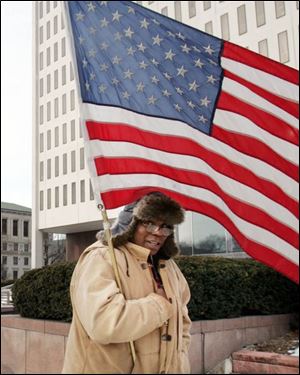 Larry Jackson, a Marine from 1969 to 1972, is one of about 50 protesting the halt of Marine training in Toledo.