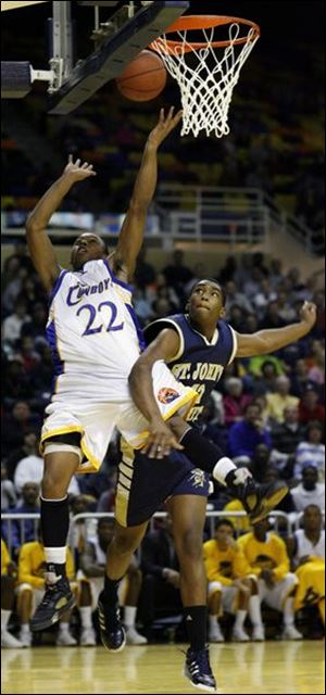 Libbey's Brad Burton (22) and St. John's Tim Simmons collide as Burton goes to the basket last night at Savage Hall. Libbey finishes the regular season 18-2.