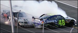 Sam Hornish Jr., left, and Jimmie Johnson make contact with just over 20 laps to go in the
Daytona 500. Hornish was able to keep his car under control and finished 15th. The field goes through turn one for the first time in the Daytona 500. Unlike other sports,
NASCAR starts the season with its biggest event, and yesterday was its 50th anniversary.