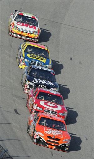 Tony Stewart leads a pack of cars late in the Daytona 500. Stewart fell from first to third on the last lap.
