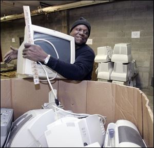 Collois Coachman prepares computers and printers in the Goodwill Industries warehouse for shipment to be recycled.