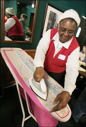 nbrw linus21p     2/16/2008         The Blade/Herral Long    Carolyn McIntosh of toledo irons quilt  Please get fotos during Make a Blanket Day for Project Linus, Toledo/Lucas County Chapter, from 10 a.m. to 3 p.m. at Charlie's Pizza in Saxon Square. Want fotos of people making the blankets that will be given to the Lucas County Children's Services for distribution to foster children. Some people will be sewing blankets, others will be doing their work without the aid of machines. Sponsors are donating machines, scissors, space, money, etc., for blankets. About 40 were made during Blanket Day last year, and the chapter hopes to make more this year.