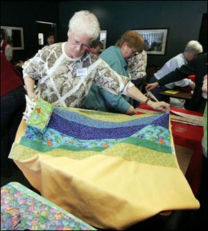 nbrw linus21p     2/16/2008         The Blade/Herral Long    NANCY FOWLER OF SYLVANIA  with pinned quilt  Please get fotos during Make a Blanket Day for Project Linus, Toledo/Lucas County Chapter, from 10 a.m. to 3 p.m. at Charlie's Pizza in Saxon Square. Want fotos of people making the blankets that will be given to the Lucas County Children's Services for distribution to foster children. Some people will be sewing blankets, others will be doing their work without the aid of machines. Sponsors are donating machines, scissors, space, money, etc., for blankets. About 40 were made during Blanket Day last year, and the chapter hopes to make more this year.