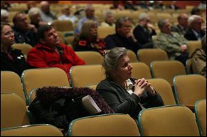 Tiffin resident Jan Dundore listens as panel members discuss the $8.5 million bond issue on the March 4 ballot.