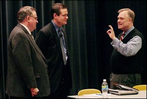 Former Tiffin mayor Bernie Hohman, left, and Seneca County Commissioner Ben Nutter, talk
with John Bing of Heidelberg College, prior to the forum start. Mr. Hohman was moderator.
