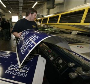 At Clear Images, on 11th Street near downtown, Todd Cutcher loads posters for an anti-reflective coating.