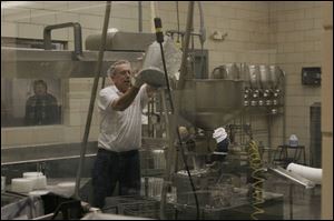 John Moden pours cottage cheese at Sterlena Pride Dairy Cooperative. 