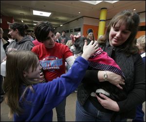 Humane Society volunteer Nora Solomon holds Spock for admirers Kortney Gonyer of Wayne, Ohio, and Stacy Smith of Luckey, Ohio.