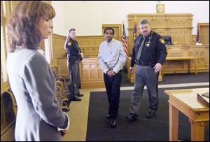 Michael Lee Dixon, 50, indicted for the murder of BGSU student
Karen Sue Hirschman, is escorted into a courtroom.
