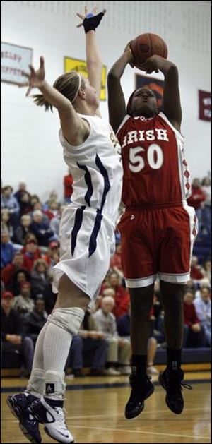 Brianna Jones fires a shot over Solon's Erin Wisner. Jones led Central Catholic with 12 points as the Irish (23-3) earned a spot in the state tournament for the first time since 2001.
