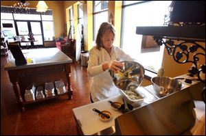Sheri VanHoosear, of Maumee, makes lasagna at Super Suppers, one of two meal prep firms.